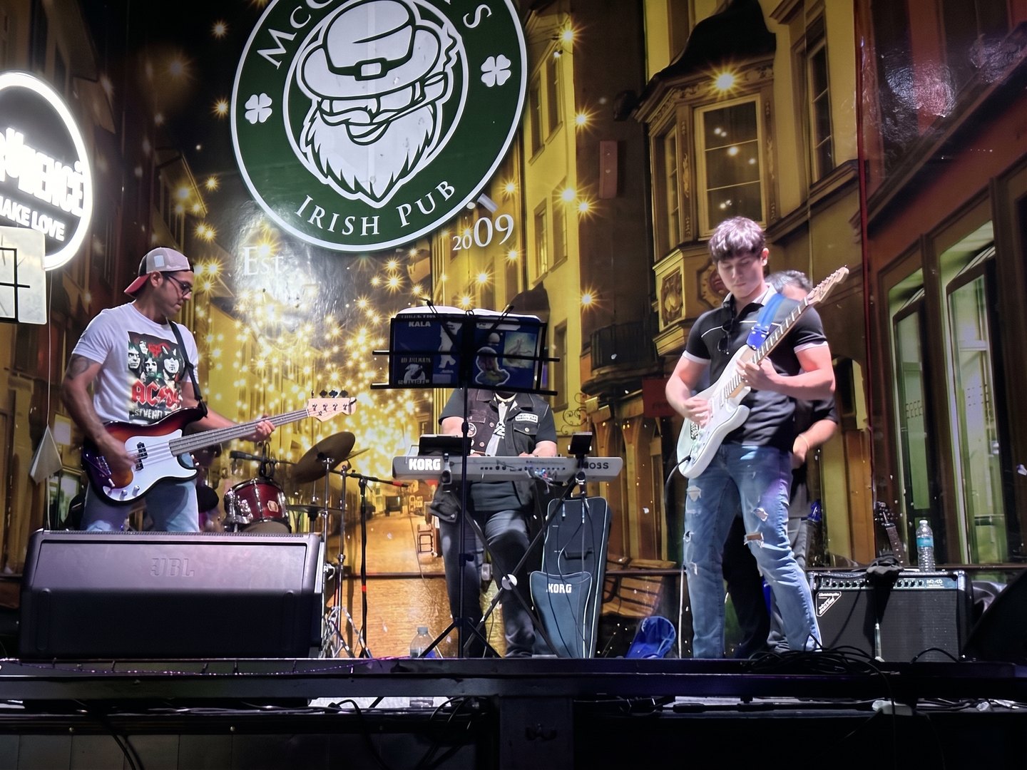 Santiago Moreno performing live on guitar under warm stage lights