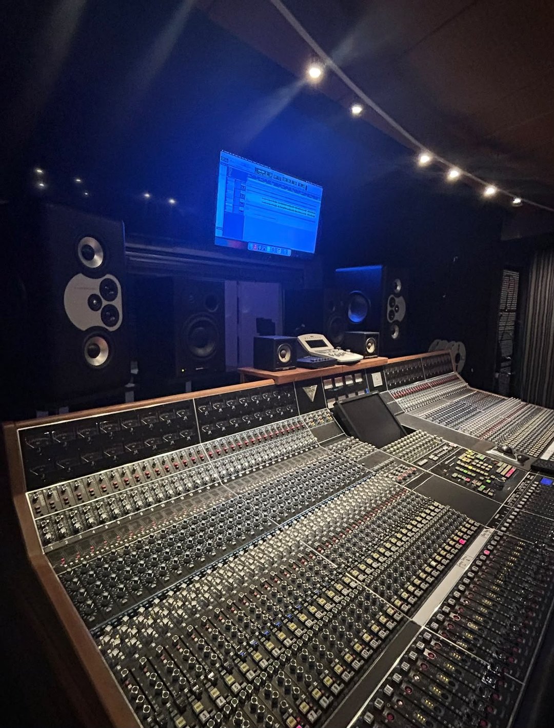 Large-format analog mixing console and outboard gear in a recording studio